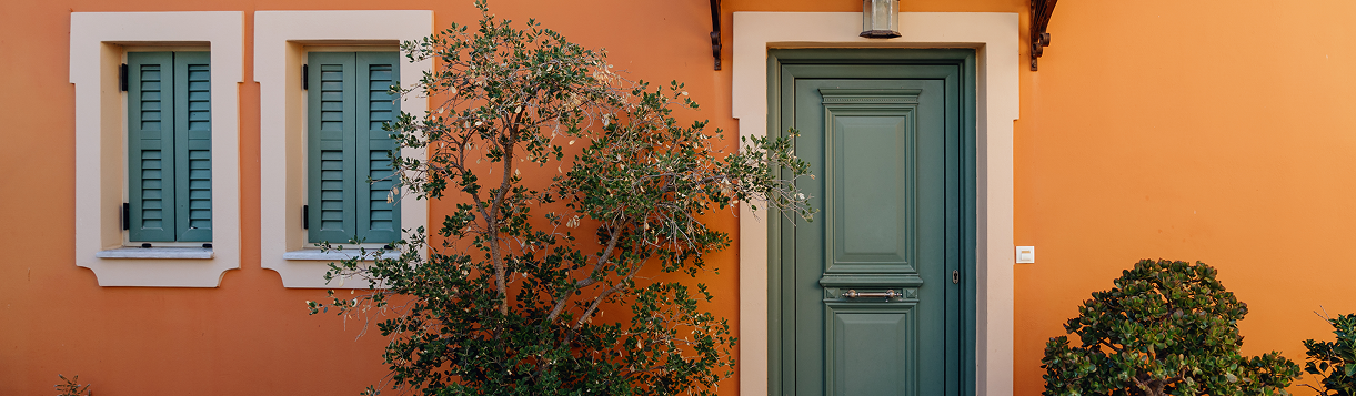 orange-facade-with-green-door-and-window-shutters-2026-03-10-03-22-37-utc 1