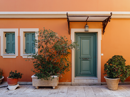 orange-facade-with-green-door-and-window-shutters-2026-03-10-03-22-37-utc 2